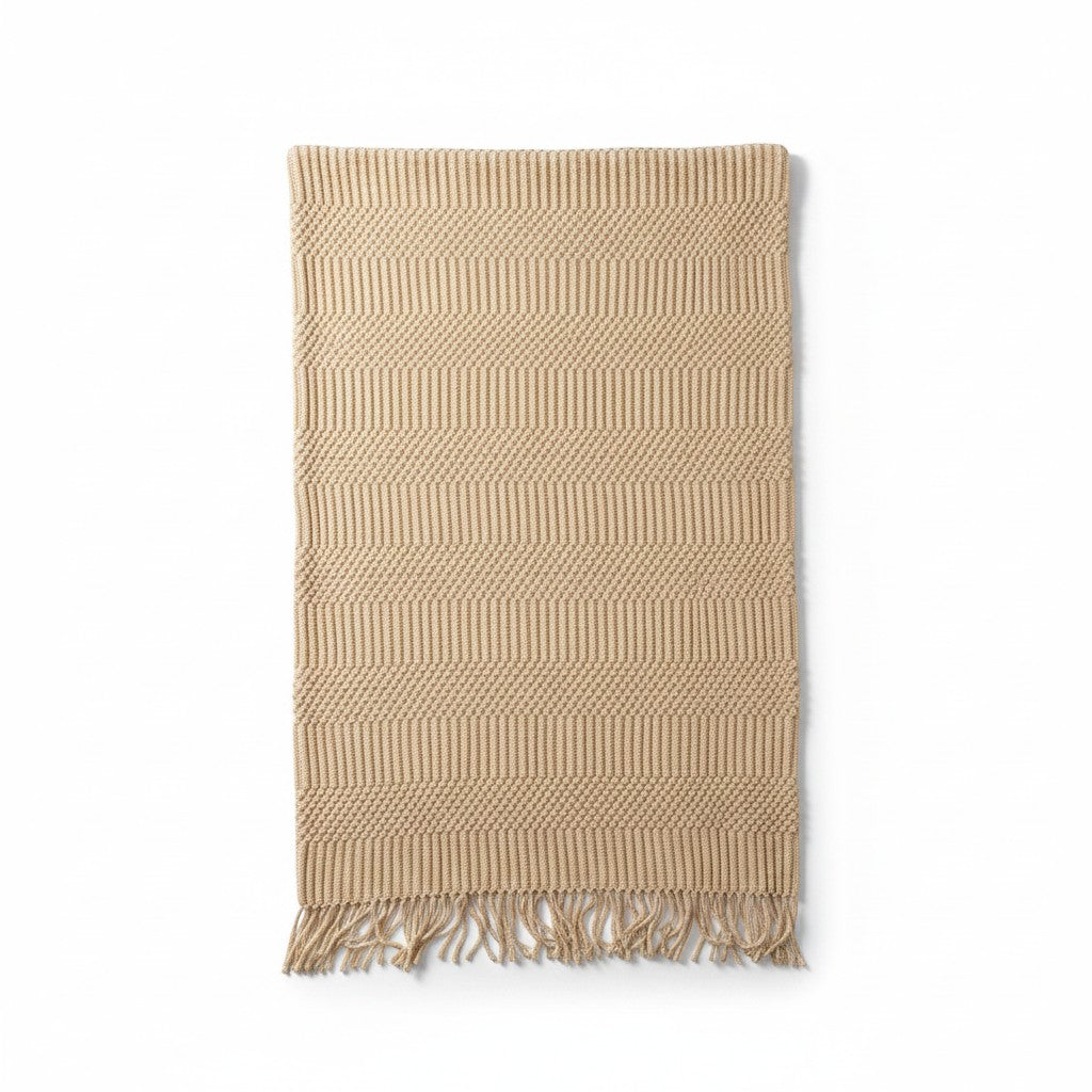 Hearthly beige knit throw blanket with geometric pattern and fringe detail. Soft, durable yarn for cozy comfort.